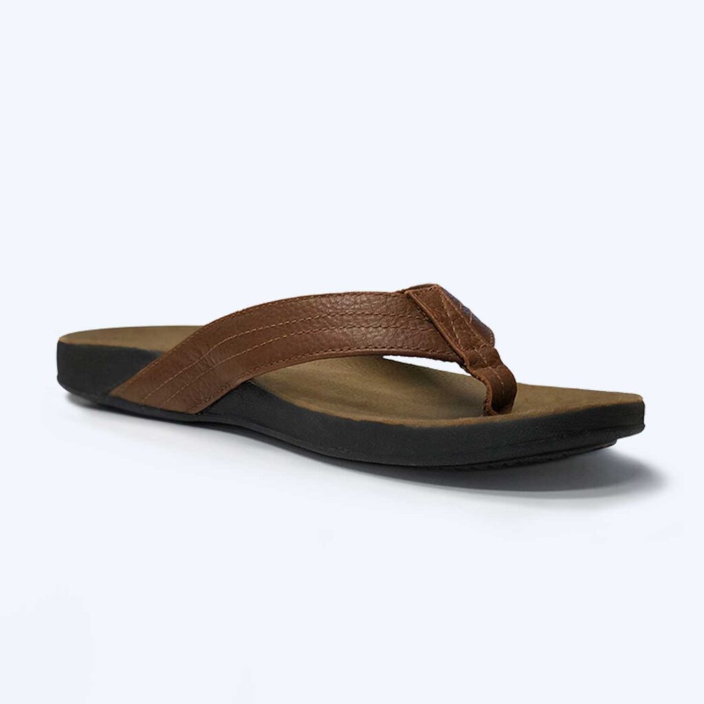 The Mens ‘Byron’ – Tan is a brown flip-flop sandal featuring a leather strap and black sole, displayed against a plain white background.